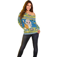 Women’s blue off-shoulder Christmas sweater with cute angel character on front