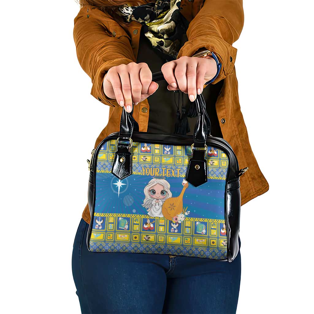 Blue star-themed shoulder handbag with black handles, gold border, and angel print