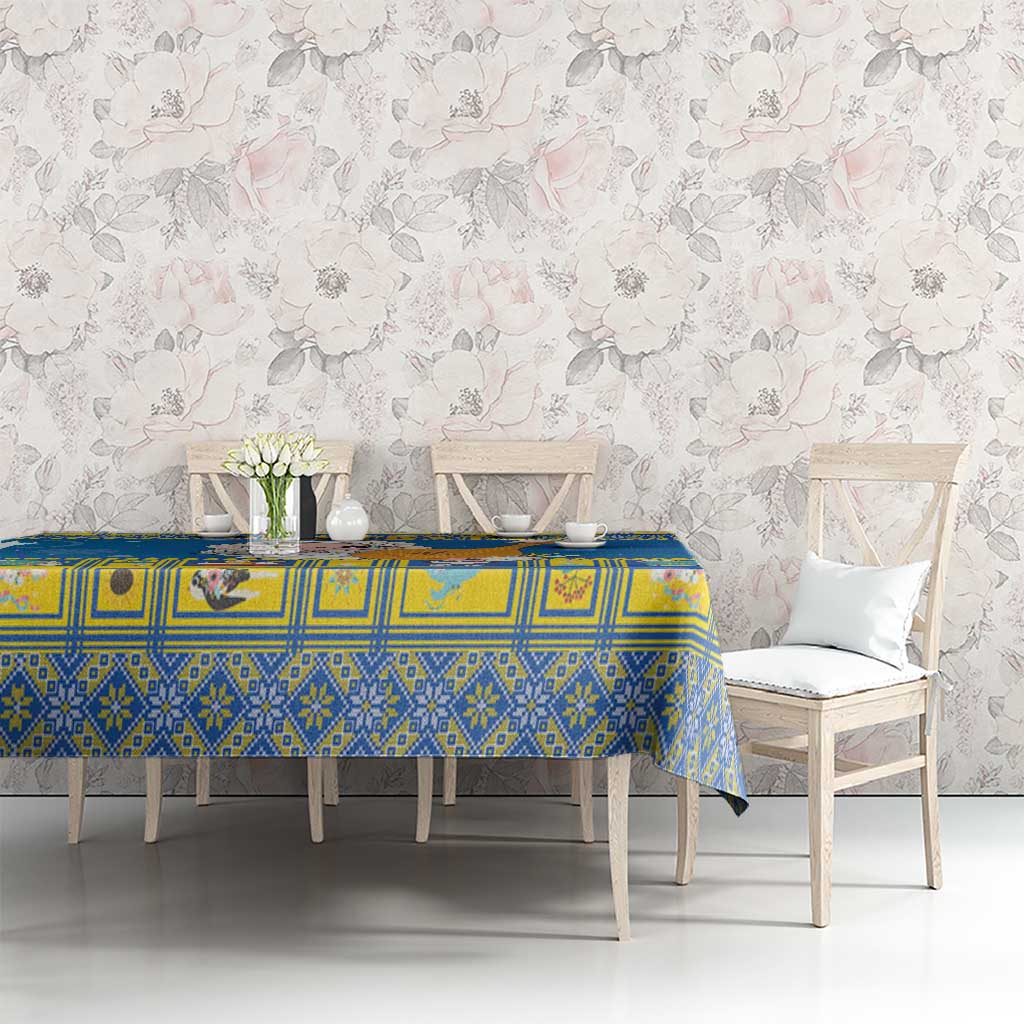 Blue patterned Christmas tablecloth on dining table with chairs