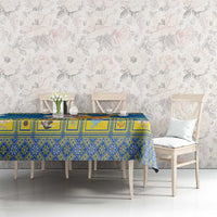 Blue patterned Christmas tablecloth on dining table with chairs