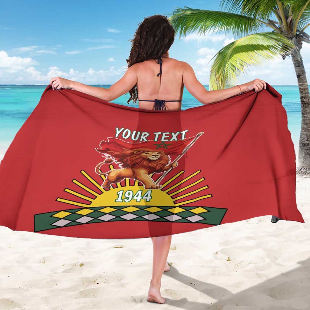 Red sarong wrap, back view, lion crest with 1944 and fan-style rays