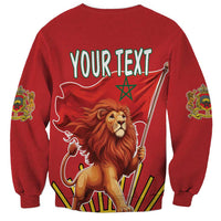 Red sweatshirt back print: YOUR TEXT over lion holding flag staffs and Moroccan crest