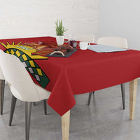 Red tablecloth with lion emblem and geometric banner design on the table