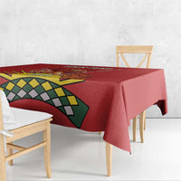 Red tablecloth corner showing lion graphic and green-yellow geometric pattern