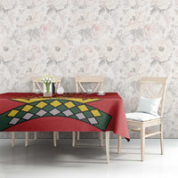 Red tablecloth with lion graphic and geometric banner design on dining table