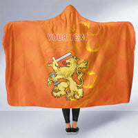 Orange hooded blanket with flame crown lion graphic and personalized text, front view