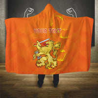 Orange hooded blanket with crown lion graphic and personalized text, hooded drape front