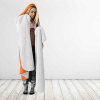 Orange hooded blanket with white fleece hood and lining, worn open