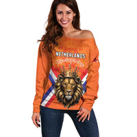 Women’s orange off-shoulder sweater with lion and crown graphic and Netherlands text