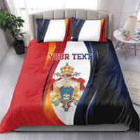 Personalized bedding set with red, blue, and white duvet featuring crest and 'YOUR TEXT'