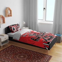 Red, black, and white tribal eagle bedding set on bed with two pillows