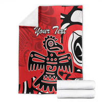 Red personalized blanket with eagle totem design, folded with two white towels