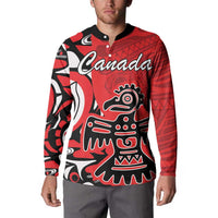 Red button-front sweatshirt with black collar, Canada script and tribal figure graphic