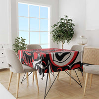 Red patterned tablecloth with bold black and white eagle graphic on table