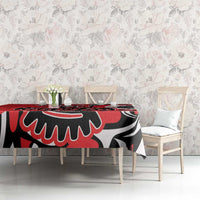 Red tablecloth featuring a black and white eagle-style design along the tabletop