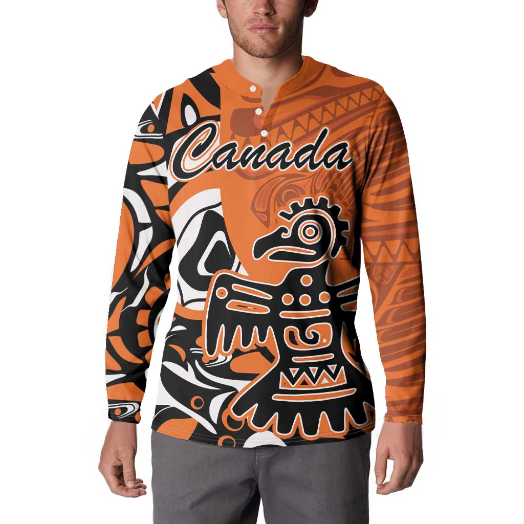 Orange button-up sweatshirt with Canada graphic and Haida eagle pattern on front