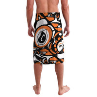 Orange and black patterned swim shorts with wide elastic waistband and abstract eagle graphic