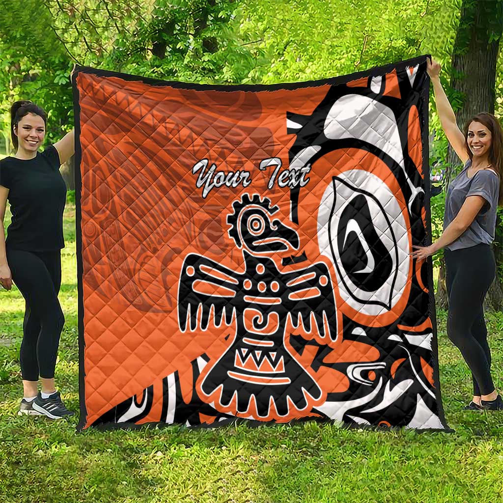 Orange quilt with Haida-style eagle graphic and “Your Text”, black and white, quilted