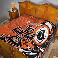 Orange quilt with Haida-style eagle graphic and “Your Text” on a bed, black and white