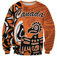 Orange sweatshirt with Canada graphic and Haida eagle illustration, long sleeves