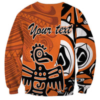Orange sweatshirt with Haida eagle graphic and "Your text" design, long sleeves