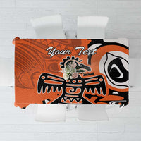 Orange, black, and white patterned tablecloth with custom text