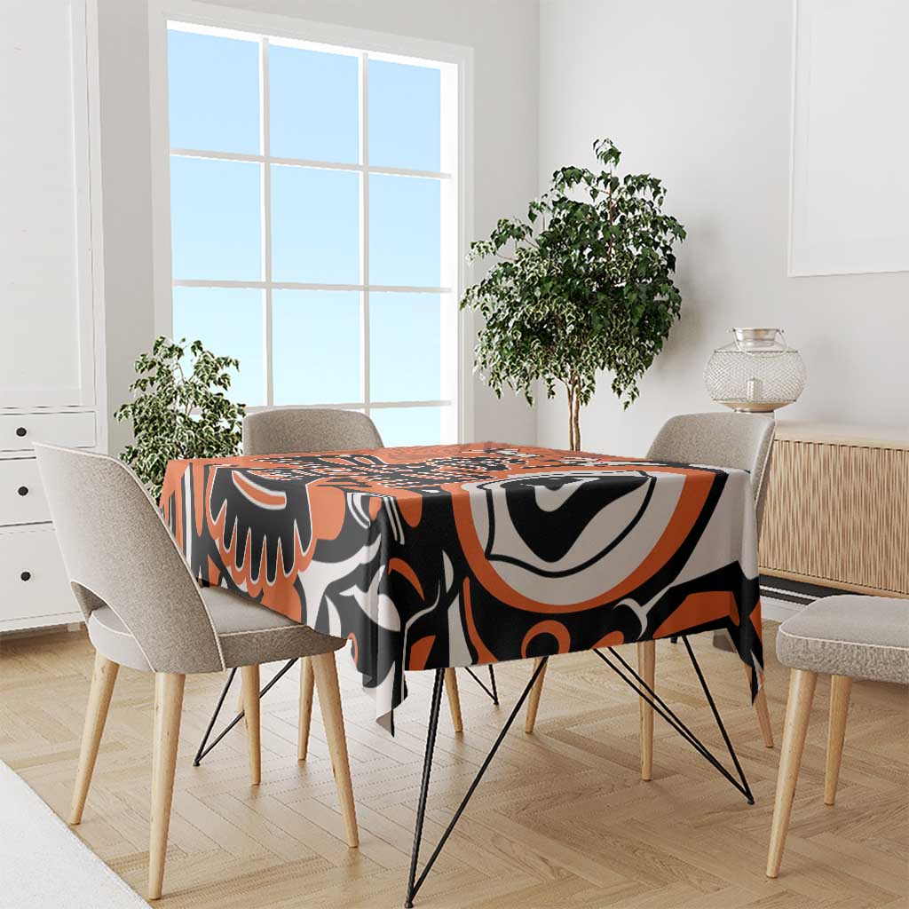 Orange patterned tablecloth with bold black and white eagle design