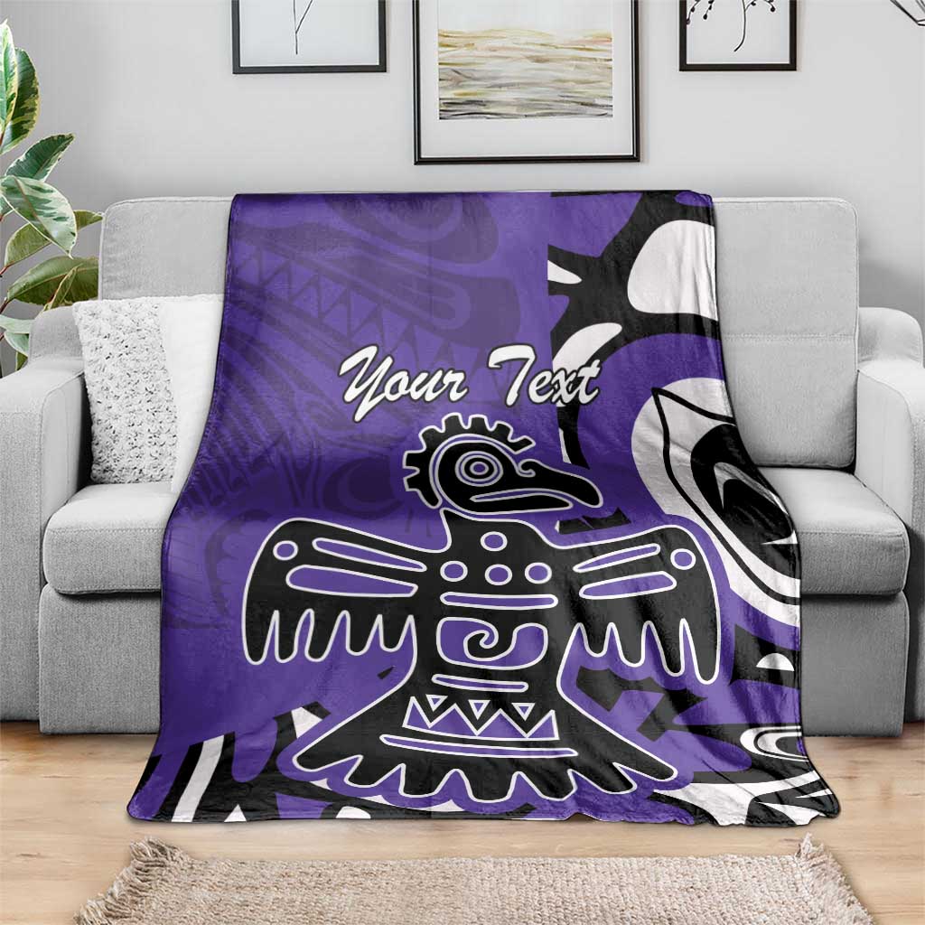 Purple blanket with eagle/Haida pattern and 'Your Text' on gray sofa