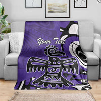 Purple blanket with eagle/Haida pattern and 'Your Text' on gray sofa