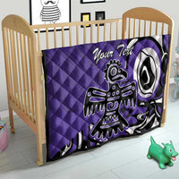 Purple quilt with custom text and Haida-style eagle graphic on a baby bed