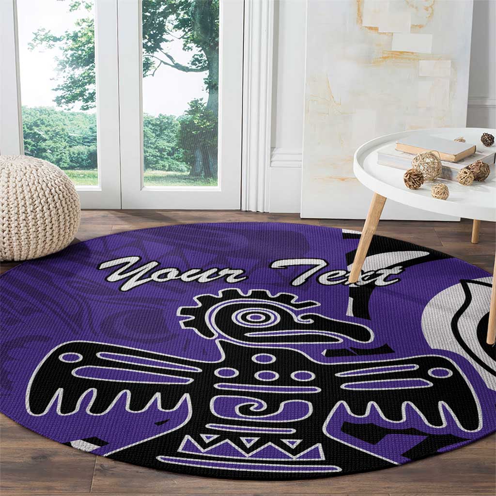 Round purple area rug with eagle graphic, laid on hardwood floor near window