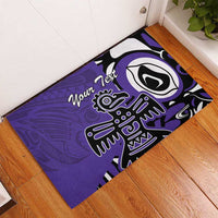 Purple rubber doormat with Haida-style eagle and bold circular eye motif