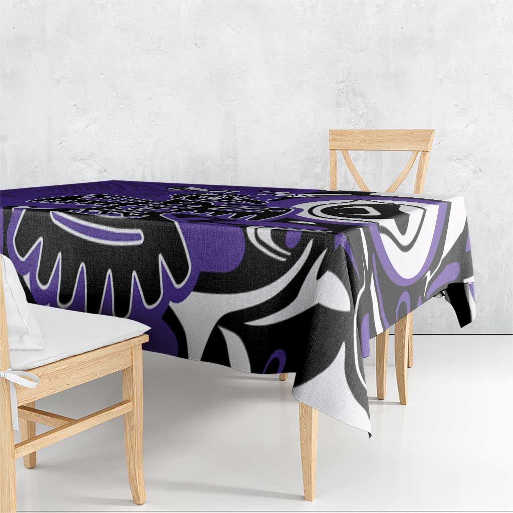 Purple tablecloth draped over a dining table with black and white tribal pattern