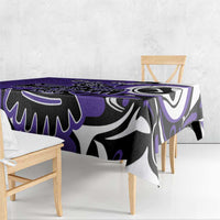Purple tablecloth draped over a dining table with black and white tribal pattern