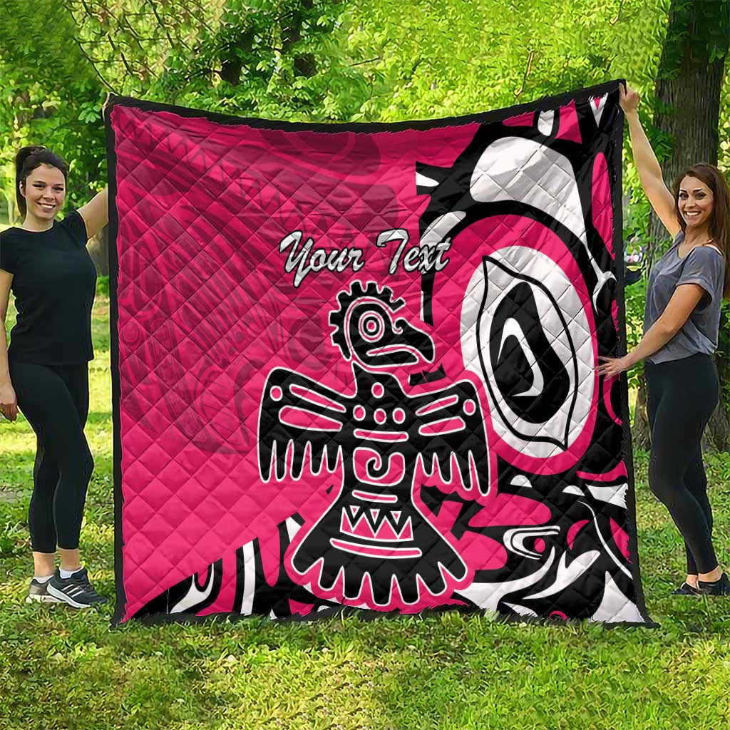 Pink quilt blanket spread on grass, black and white eagle graphic and custom text