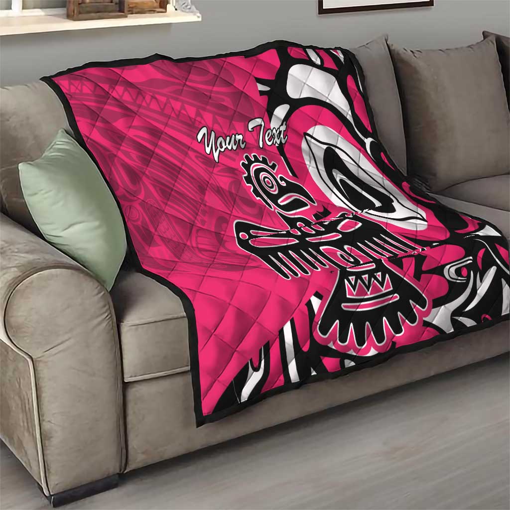 Pink quilt blanket on gray couch, black and white eagle graphic with custom text