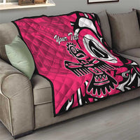 Pink quilt blanket on gray couch, black and white eagle graphic with custom text
