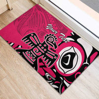 Pink rubber doormat with Haida eagle art in black/white and “Your Text”
