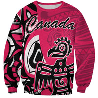 Pink crewneck sweatshirt with Canada word and Haida eagle graphic, long sleeves