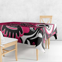 Pink tablecloth on dining table with black-and-white eagle-style graphic pattern