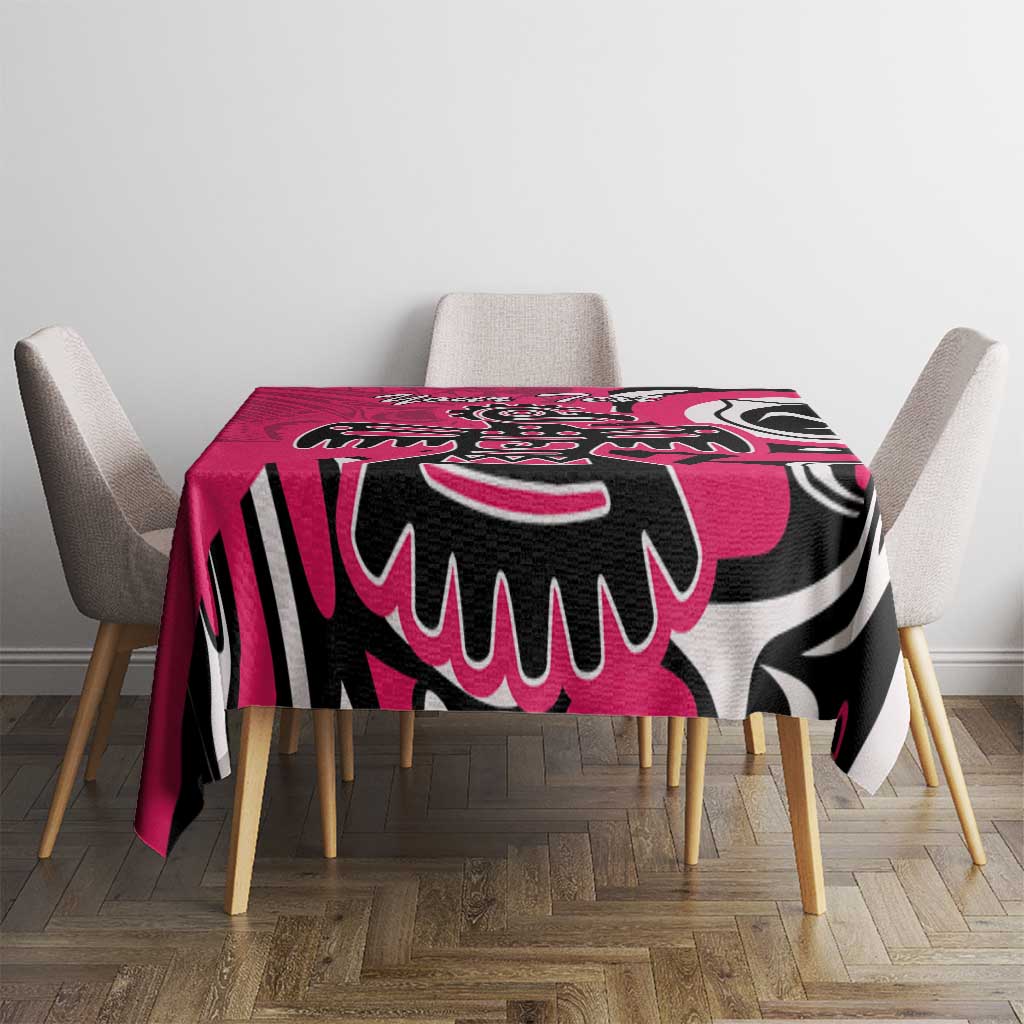 Pink patterned tablecloth with black-and-white eagle design across the tabletop