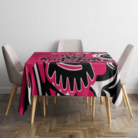 Pink patterned tablecloth with black-and-white eagle design across the tabletop