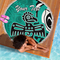 Turquoise round beach blanket with fringe, eagle graphic and 'Your Text' text on deck