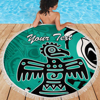 Turquoise round beach blanket with fringe, eagle graphic and 'Your Text' text on wooden deck
