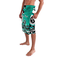Turquoise tribal print board shorts with custom text placeholder, side view
