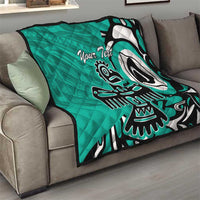 Turquoise quilt with Haida-style eagle artwork and “Your Text,” on sofa