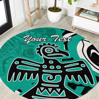 Turquoise round carpet with bold black and white eagle design and 'Your Text' banner.