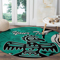 Turquoise round area rug with black and white eagle graphic and 'Your Text'.