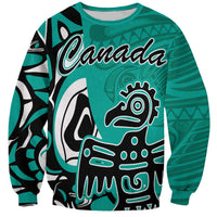 Turquoise sweatshirt with 'Canada' print and Haida-style eagle face