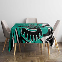 Turquoise tablecloth with black and white tribal eagle pattern, draped over square table
